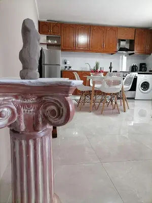 a kitchen and dining room with a table and chairs at Sunrise Apartment 2 in Souda