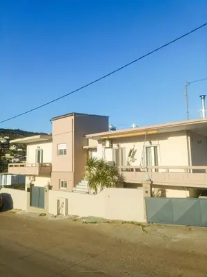 a building with a fence next to a street at Sunrise Apartment 2 in Souda