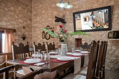 a dining room with a table and a mirror at Villa Kritiko Archontiko in Koprána