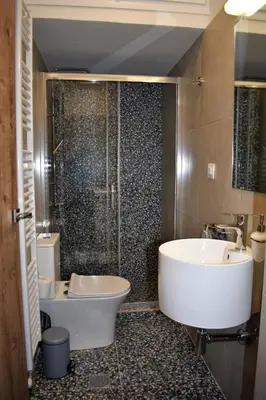 a bathroom with a tub and a sink and a shower at Saxon's Apartment in Chania Town