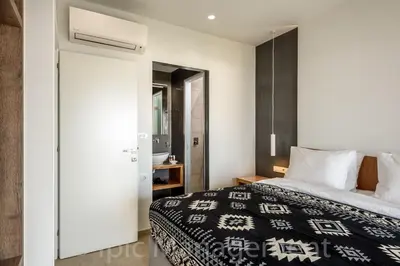 a bedroom with a bed and a mirror at Seafront VILLA PELAGIA SUPERB New listing in Chania Town