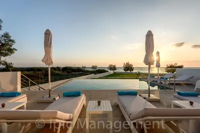 a villa with a pool and a swimming pool at Seafront VILLA PELAGIA SUPERB New listing in Chania Town