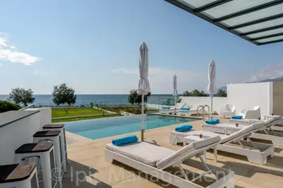 a view of the swimming pool and the ocean in a villa at Seafront VILLA PELAGIA SUPERB New listing in Chania Town