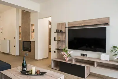 a living room with a large flat screen tv at Cataleya Villa Chania in Daratso