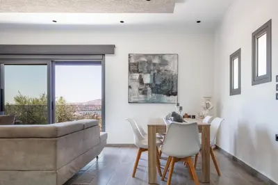 a living room with a table and a couch at ÉTHAFOS Luxury Apartment in Tsikalariá