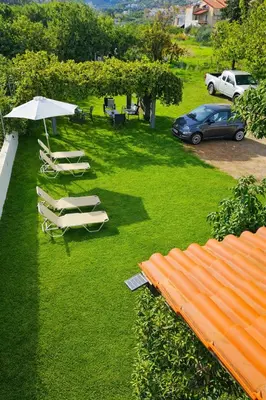 an overhead view of a lawn with chairs and an umbrella at Giannis & Maria Gramvousaki Apts in Agia Marina Nea Kydonias