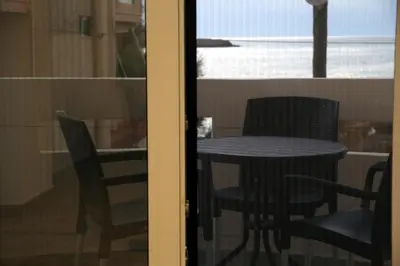 a table and chairs in a room with a window at THALIA APARTMENTS CHANlA in Chania Town