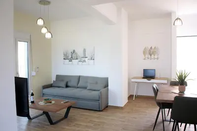 a living room with a couch and a table at THALIA APARTMENTS CHANlA in Chania Town