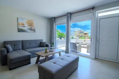 a living room with a couch and a table at Vakakis Family Luxury Studios in Palaiochóra