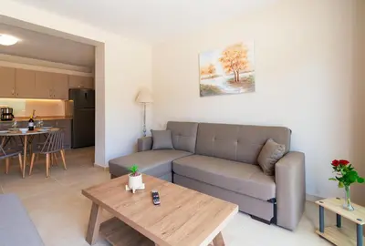 a living room with a couch and a table at Vakakis Family Luxury Studios in Palaiochóra