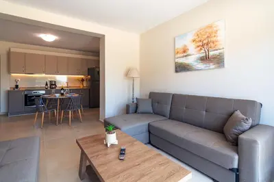 a living room with a couch and a table at Vakakis Family Luxury Studios in Palaiochóra