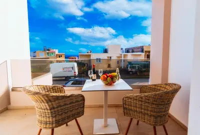 a table with a bowl of fruit on a balcony at Vakakis Family Luxury Studios in Palaiochóra