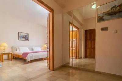 a bedroom with a bed and a glass doorway at Hotel Elman in Palaiochóra