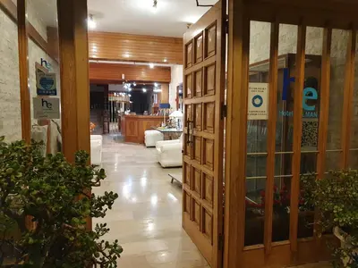 a lobby with a wooden door in a store at Hotel Elman in Palaiochóra