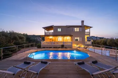 a house with a swimming pool on a deck at Casa de philippe with unique Seaview 2' from beach in Ayiá