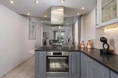 a kitchen with a stove and a counter top at Casa de philippe with unique Seaview 2' from beach in Ayiá