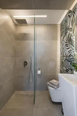 a bathroom with a shower with a toilet and a sink at Casa de philippe with unique Seaview 2' from beach in Ayiá