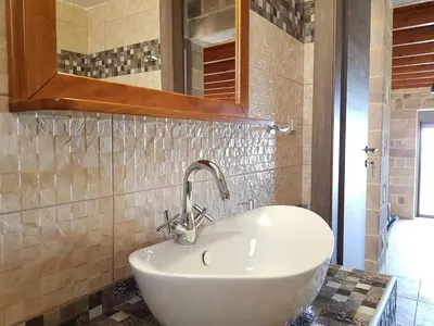 a bathroom with a sink and a mirror at New Villa Kalimera, view to Falasarna beach in Plátanos