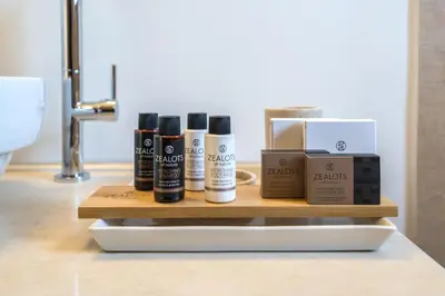 a shelf with four products on a bathroom counter at FOS residence - ΦΩΣ ,luxury villa in Chania Town