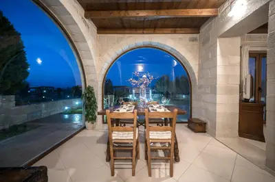 a dining room with a table and a large window at FOS residence - ΦΩΣ ,luxury villa in Chania Town