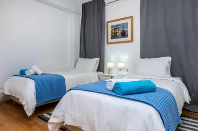 two beds in a room with blue and white at DIMITRA apartment with private pool and sea view -the ground floor of a two storey building in Daratso