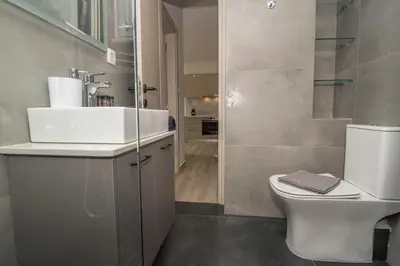 a bathroom with a white sink and a toilet at Allview apartments in Palaiochóra