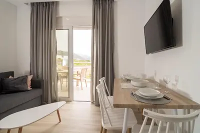 a living room with a dining table and a couch at Allview apartments in Palaiochóra