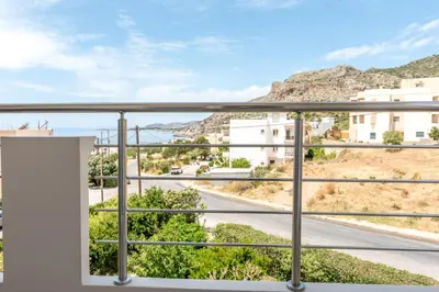 a balcony with a view of a road and mountains at Allview apartments in Palaiochóra