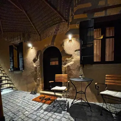 a room with a table and chairs in a building at Sclopa The Laography Project in Kolymvari