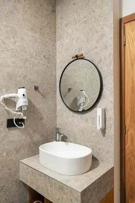 a bathroom with a white sink and a mirror at Diamond Star Hotel in Falasarna