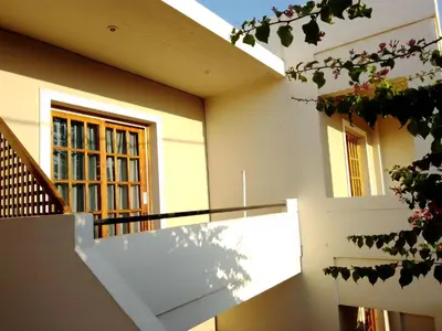 a building with a staircase and a window at Irini Apartments in Plataniás
