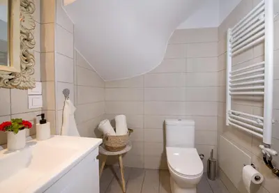 a white bathroom with a toilet and a sink at World Villa in Tavronitis
