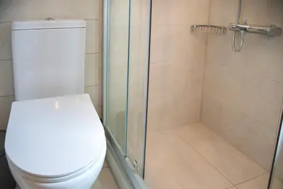 a bathroom with a toilet and a glass shower at World Villa in Tavronitis