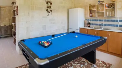 a pool table in a kitchen with at World Villa in Tavronitis