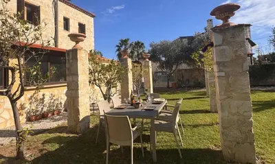 a table and chairs in the yard of a house at World Villa in Tavronitis