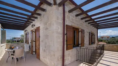a patio of a house with a wooden ceiling at World Villa in Tavronitis