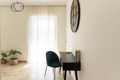a room with a desk and a chair and a clock on the wall at Dream Casa by the Sea by 8essentially in Chania Town