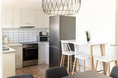 a kitchen with a stainless steel refrigerator and white cabinets at Dream Casa by the Sea by 8essentially in Chania Town