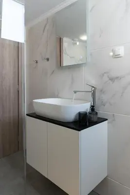 a white bathroom with a sink and a mirror at Dream Casa by the Sea by 8essentially in Chania Town
