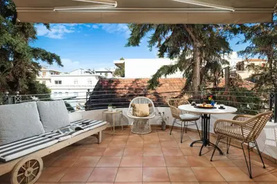 a patio with a bench and a table and chairs at Orion Chania Boutique City House in Chania Town