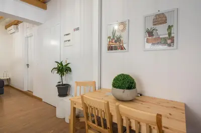 a dining room with a table with a potted plant on it at Mariviky design apartment in Chania Town