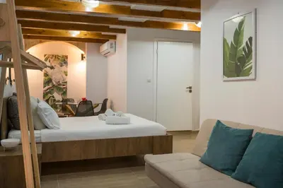 a living room with a bed and a couch at Mariviky design apartment in Chania Town