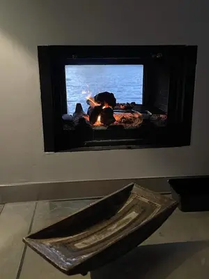 a fireplace with a fire in it in a room at Villa Yasemi panoramic sea view in Chania Town