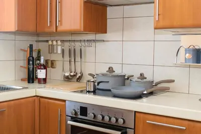 a kitchen with a stove with pots and pans on it at Central penthouse in quiet neighborhood near sandy beach in Chania Town