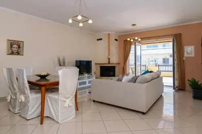 a living room with a couch and a table at Central penthouse in quiet neighborhood near sandy beach in Chania Town