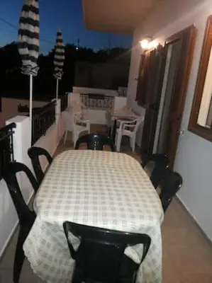 a table on a balcony with a table and chairs at VILLA ANNA in Ravdhoúkha