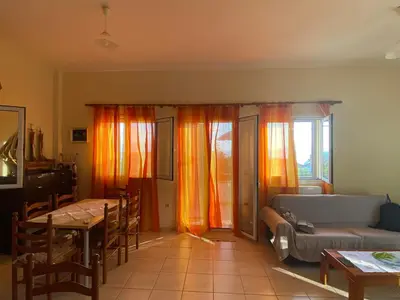 a living room with a couch and a table at VILLA ANNA in Ravdhoúkha