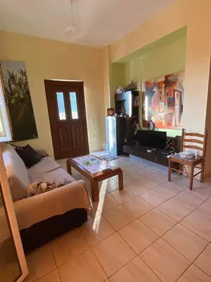 a living room with a couch and a table at VILLA ANNA in Ravdhoúkha