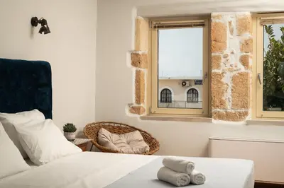 a bedroom with a bed and a window at Mansion D in Galatás