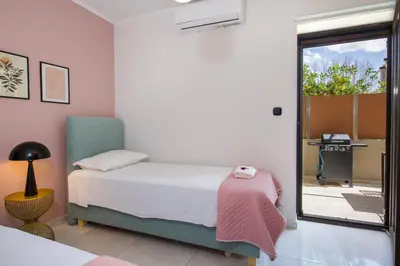a bedroom with a bed and a sliding glass door at Anastasia & Maria Luxury Residence in Kissamos